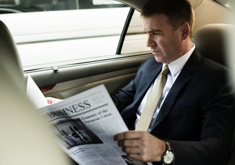 Businessman Reading Newspaper Car Inside