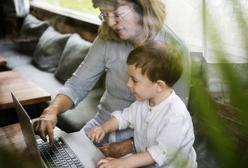 Fototapeta na wymiar Grandmother Grandson Family Laptop Digital