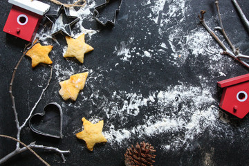 New Year or Christmas background with Xmas decorations and backed cookies on dark wooden chalkboard