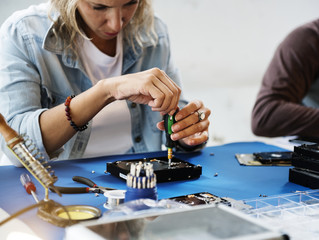 Technicians working on computer hard disk