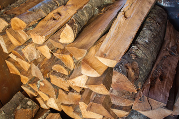 Woodpile of chopped lumber. Pile of wood logs. Stacked firewood timber