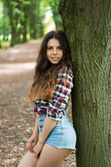 Naklejka premium Young beautiful girl in the park