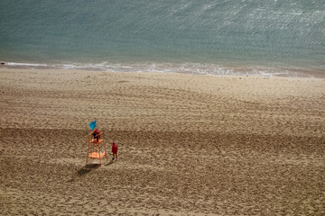 Fototapeta na wymiar empty beach with only two lifeguards