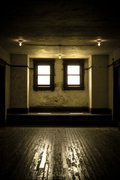 Empty Room. Bare Light Bulbs And Hardwood Floor In Outdated And Dreary Empty Room.