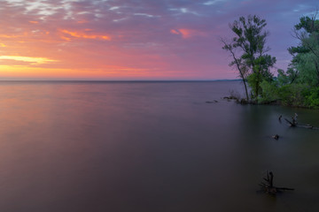 Fototapeta na wymiar purple dawn on the river / neutral grey filter long exposure