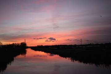Sunset over the ring canal in Nieuwerkerk aan den IJssel with nice colors and reflection in water