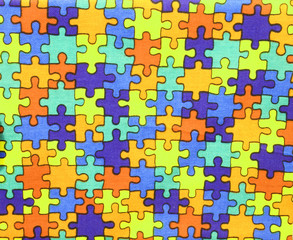 pieces of colored puzzle on cotton fabric