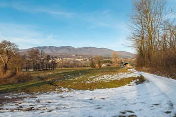 Rural landscape in winter on the shores of Lake Varese, Voltorre, province of Varese (Lombardy, Italy). In the background is the village of Comerio and the regional park Campo dei Fiori