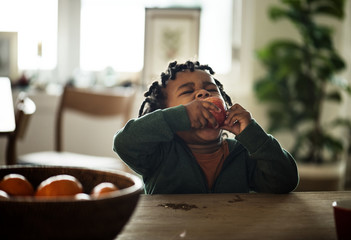 Black kid eating fruit