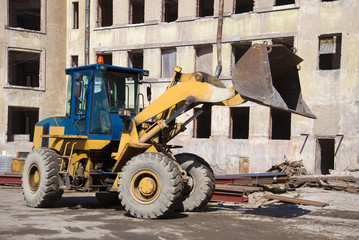 Heavy forklift close-up on the reconstruction of old apartment house. Kronstadt