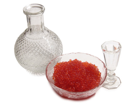 Fish caviar and glass of vodka on a white background
