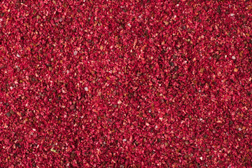 Dried sumac spice as a background, natural seasoning texture
