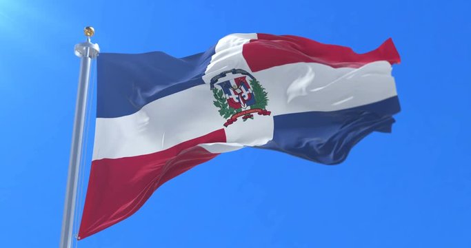 Flag of the Dominican Republic waving at wind with blue sky in slow, loop
