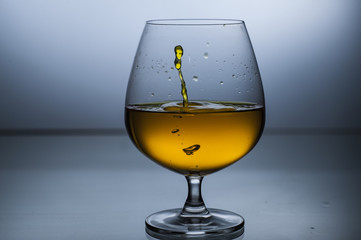 Big wine glasses with liquid splashes