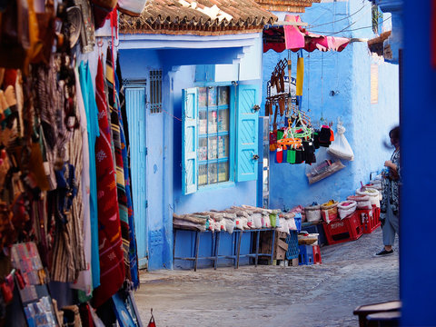 The gorgeous blue alleyways and blue-washed building with the souvenirs in Chefchaouen, Morocco 