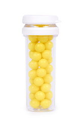 Medicine bottle with vitamins in hand isolated on white background, transparent container with pills, yellow balls