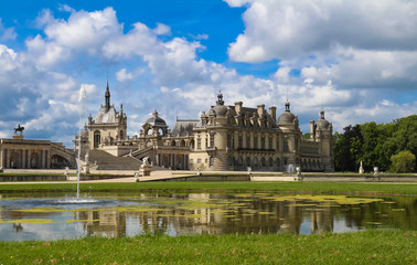 The castle of Chantilly is historical and architectural monument, France. - obrazy, fototapety, plakaty