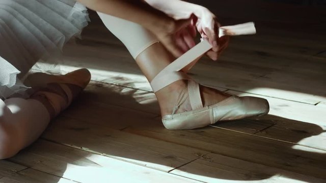 Ballet dancer dressing up ballet shoes