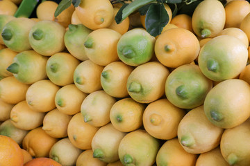 Ripe lemons on a layout in a vegetable store.