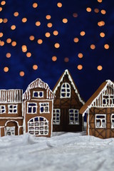 home made gingerbread village with bokeh sky out of blue velvet and christmaslights as advent decoration for the family