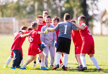 Kids soccer football -  children players celebrating after victory
