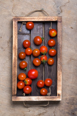 Fresh vegetables and herbs on a wooden burned rustic texture for background. Rough weathered wooden board