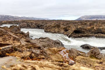 Water of stormy mountain river from waterfall - beautiful part of stony rocky desert landscape of Iceland