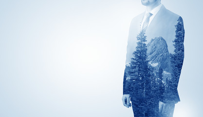 Businessman standing with mountain
