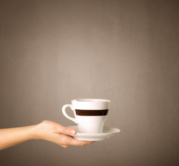 Female hand holding coffee cup