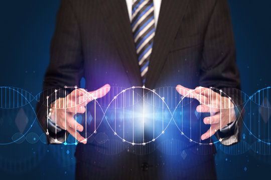 Businessman holding DNA - Powered by Adobe