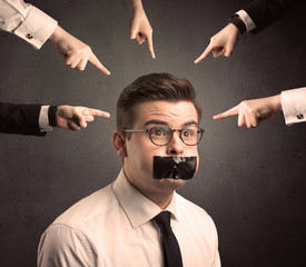 multiple hands pointing at business employee