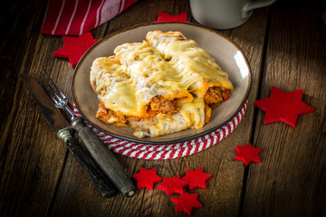Italian lasagna rolls on a plate. Small depth of field.