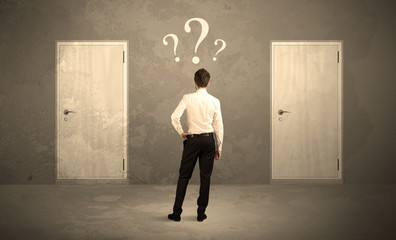 Businessman standing in front of doors