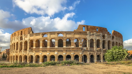 Fototapeta premium Sunset at the Colosseum with clouds, with no people, Flavian Amphitheatre, the largest amphitheater in the world and one of the symbols of Italy and Rome.