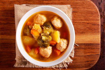 Soup with brussels sprouts, chicken balls and red lentil