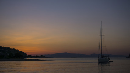 Sunrise with sailboat at sea