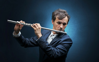 Flutist playing on instrument with empathy