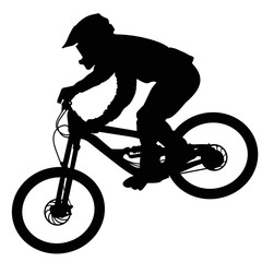 Silhouette of a cyclist going down on a mountain bike on a slope