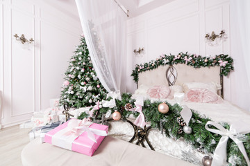 Cozy Christmas home interior. New year decoration. bright bedroom room with large double bed.