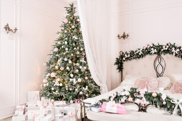 Cozy Christmas home interior. New year decoration. bright bedroom room with large double bed.