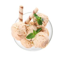 Glass bowl with caramel ice cream on white background