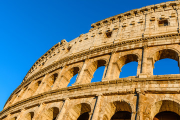 Sunset colors on the Colosseum or Coliseum, the Flavian Amphitheatre, Rome, Italy