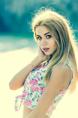 Naklejka premium A young woman or girl walks on a summer European city