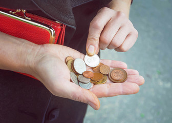 Coins in female hands, selective focus.