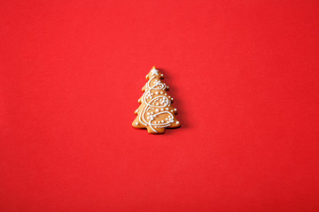 Gingerbread tree on a red background. The basis for the design of the poster or postcards. It is possible to cut at a square, horizontal or vertical format.