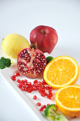 Pomegranate and Colorful Fruits on White Background