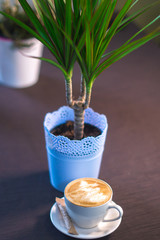 A cup of coffee with a picture in a cafe.