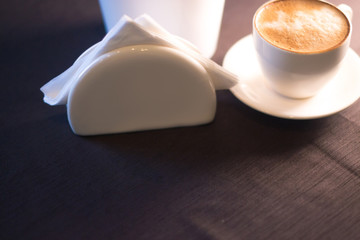 A cup of coffee with a picture in a cafe.