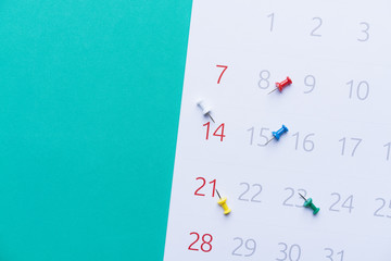 close up of calendar on green background, planning for business meeting or travel planning concept