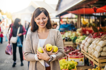 Woman buying some healthy food at green market place.